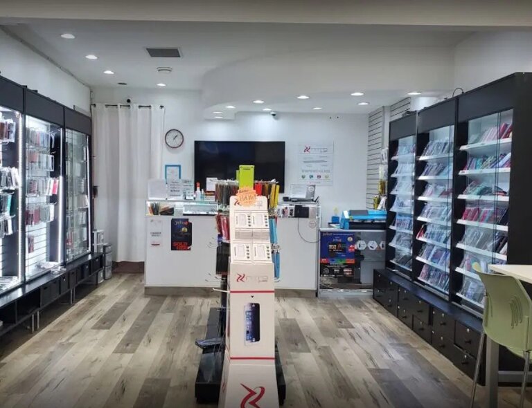 Inside the Cellfixx store on Fraser Street, Vancouver — the service counter and accessory wall